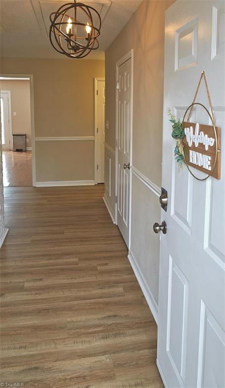 1012 Springwood Lane Archdale, NC 27370 - Photo 6 of 46 Spacious entry with a coat closet on the right, and a doorway into the kitchen on the left. Updated lighting fixture.