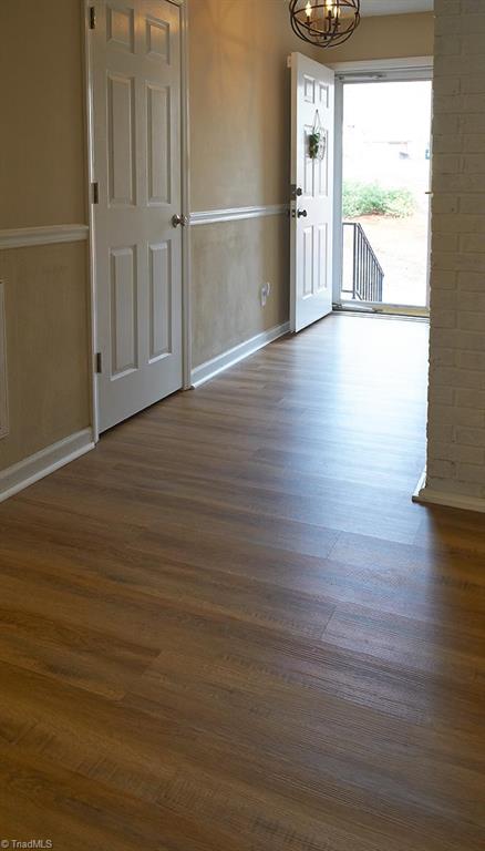 1012 Springwood Lane Archdale, NC 27370 - Photo 7 of 46 View of the entry from the kitchen doorway. Laminate flooring and coat closet.