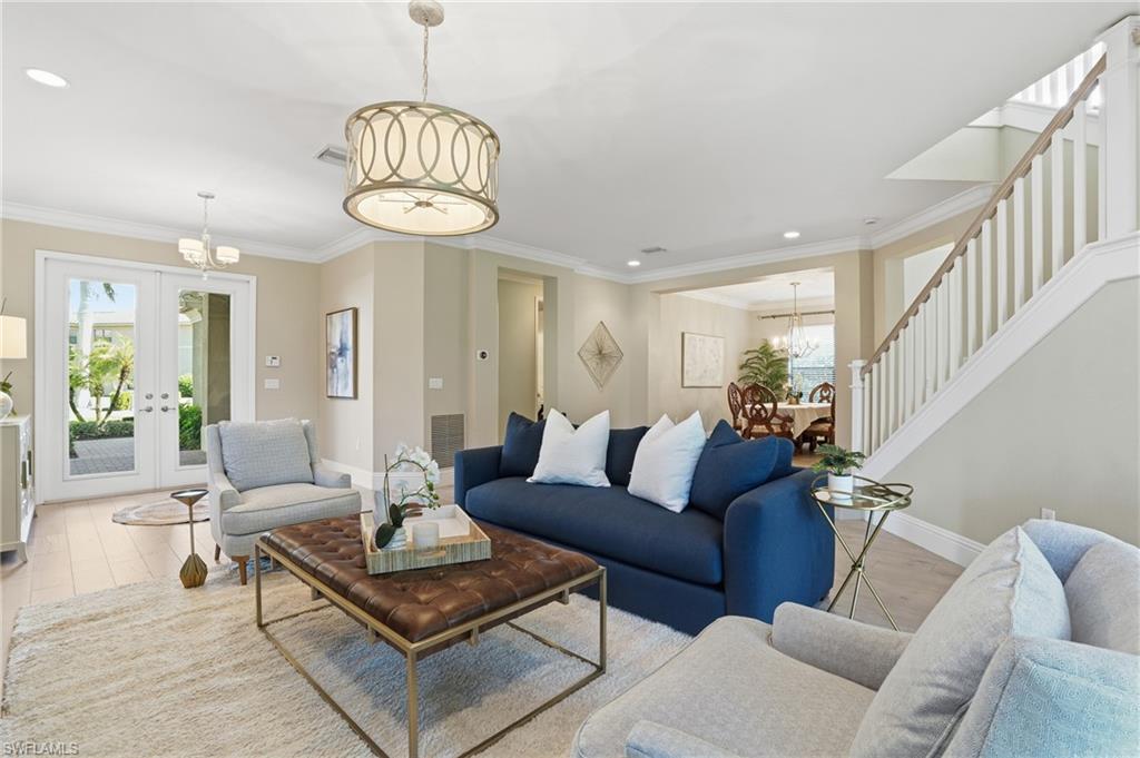 13768 Luna Drive Naples, FL 34109 - Photo 11 of 44 a living room with furniture a chandelier and a chandelier