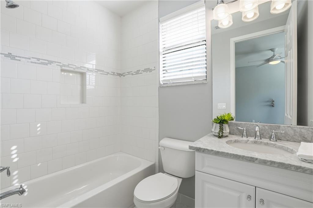 13768 Luna Drive Naples, FL 34109 - Photo 35 of 44 a bathroom with a granite countertop sink toilet and shower