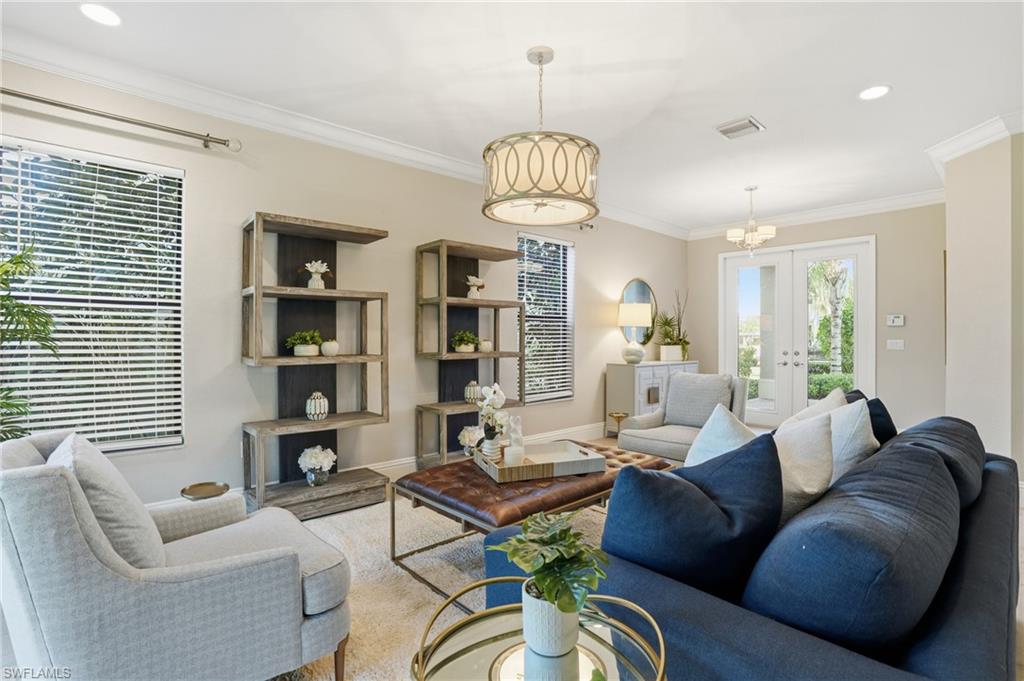 13768 Luna Drive Naples, FL 34109 - Photo 10 of 44 a living room with furniture a chandelier and a window