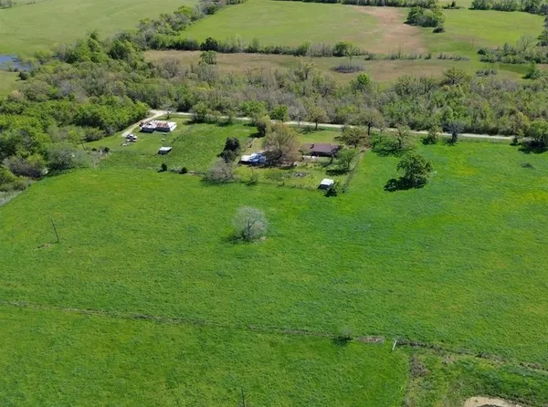 an aerial view of a house with a yard