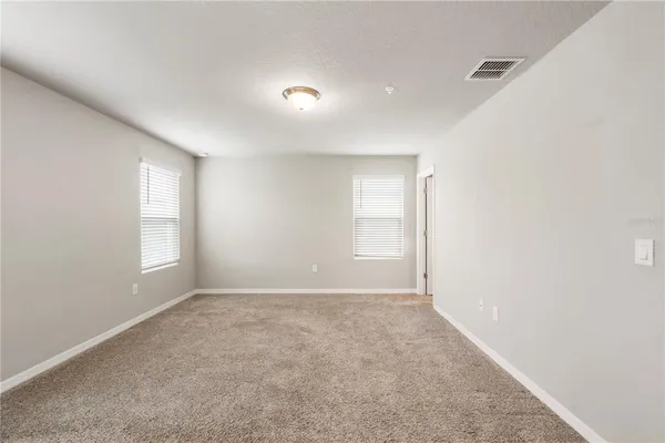 a view of empty room with windows
