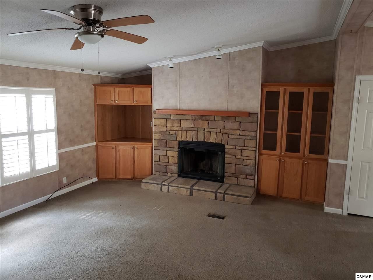 1033 Beard Valley Road Maynardville, TN 37807 - Photo 8 of 22 a view of a livingroom with a fireplace and window