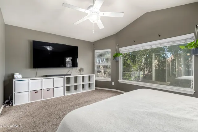 a bedroom with a large bed and a flat screen tv