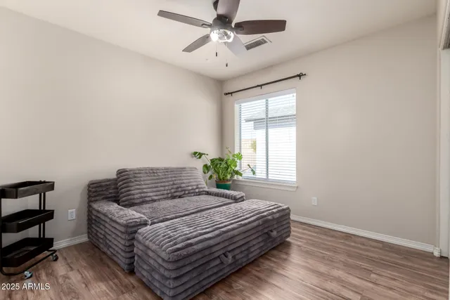 a bedroom with a bed and a ceiling fan