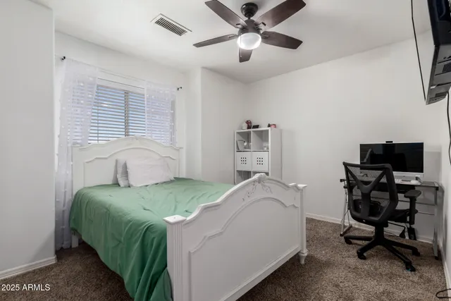 a bedroom with a bed and a desk