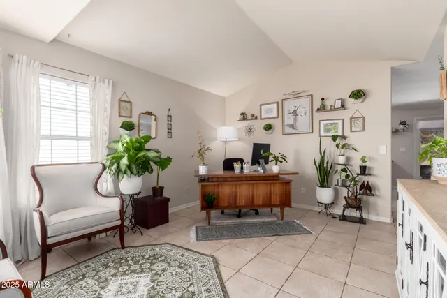 a living room with furniture and a potted plant