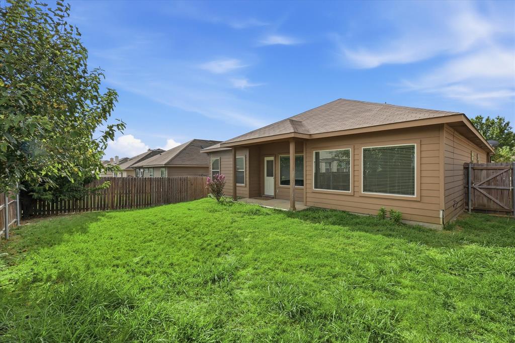 720 Rio Bravo Drive Fort Worth, TX 76052 - Photo 34 of 38 Expansive backyard featuring a partial privacy fence and mature landscaping