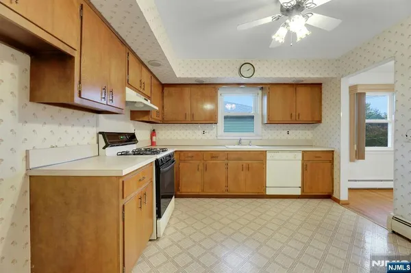 a kitchen with stainless steel appliances a stove a sink and a refrigerator