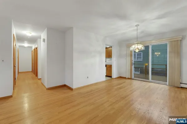 a view of an empty room with glass door