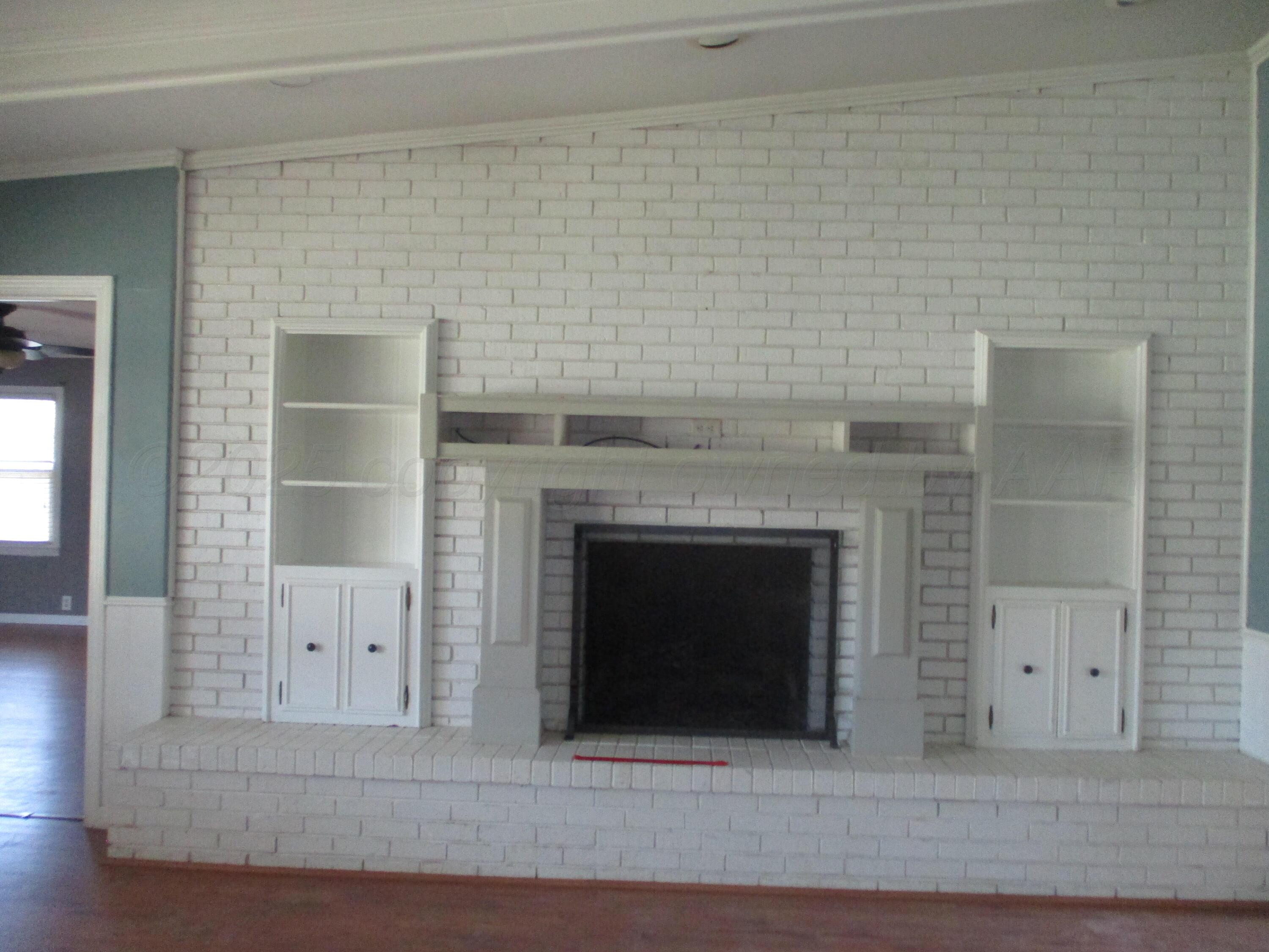 6702 Calumet Road Amarillo, TX 79106 - Photo 3 of 30 Fireplace and Built-in Bookcases in Den