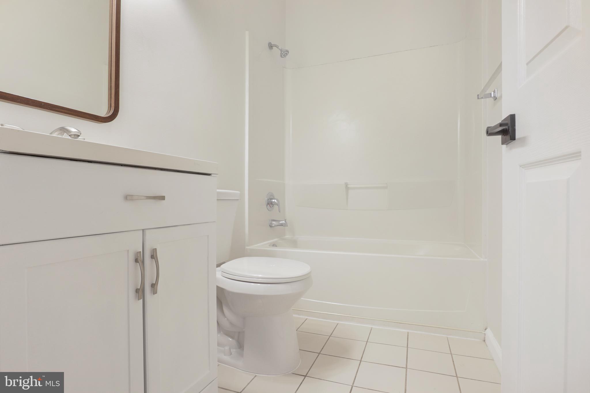 130B Remsen Avenue New Brunswick, NJ 08901 - Photo 12 of 33 a bathroom with a bathtub a toilet and a shower