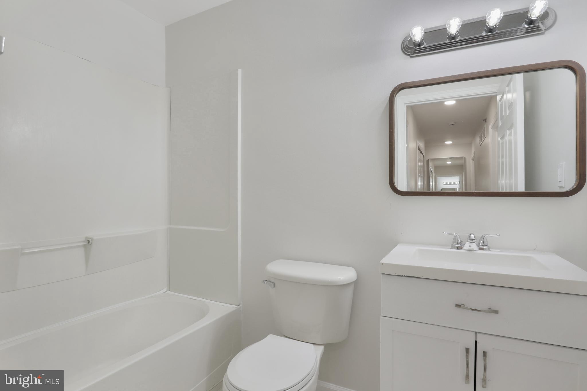 130B Remsen Avenue New Brunswick, NJ 08901 - Photo 17 of 33 a bathroom with a toilet sink and bathtub