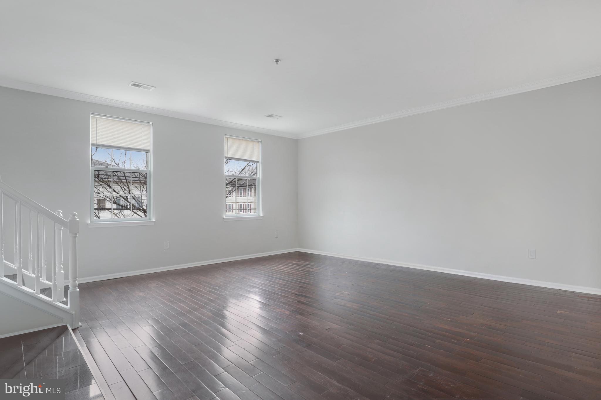 130B Remsen Avenue New Brunswick, NJ 08901 - Photo 6 of 33 a view of an empty room with wooden floor and a window