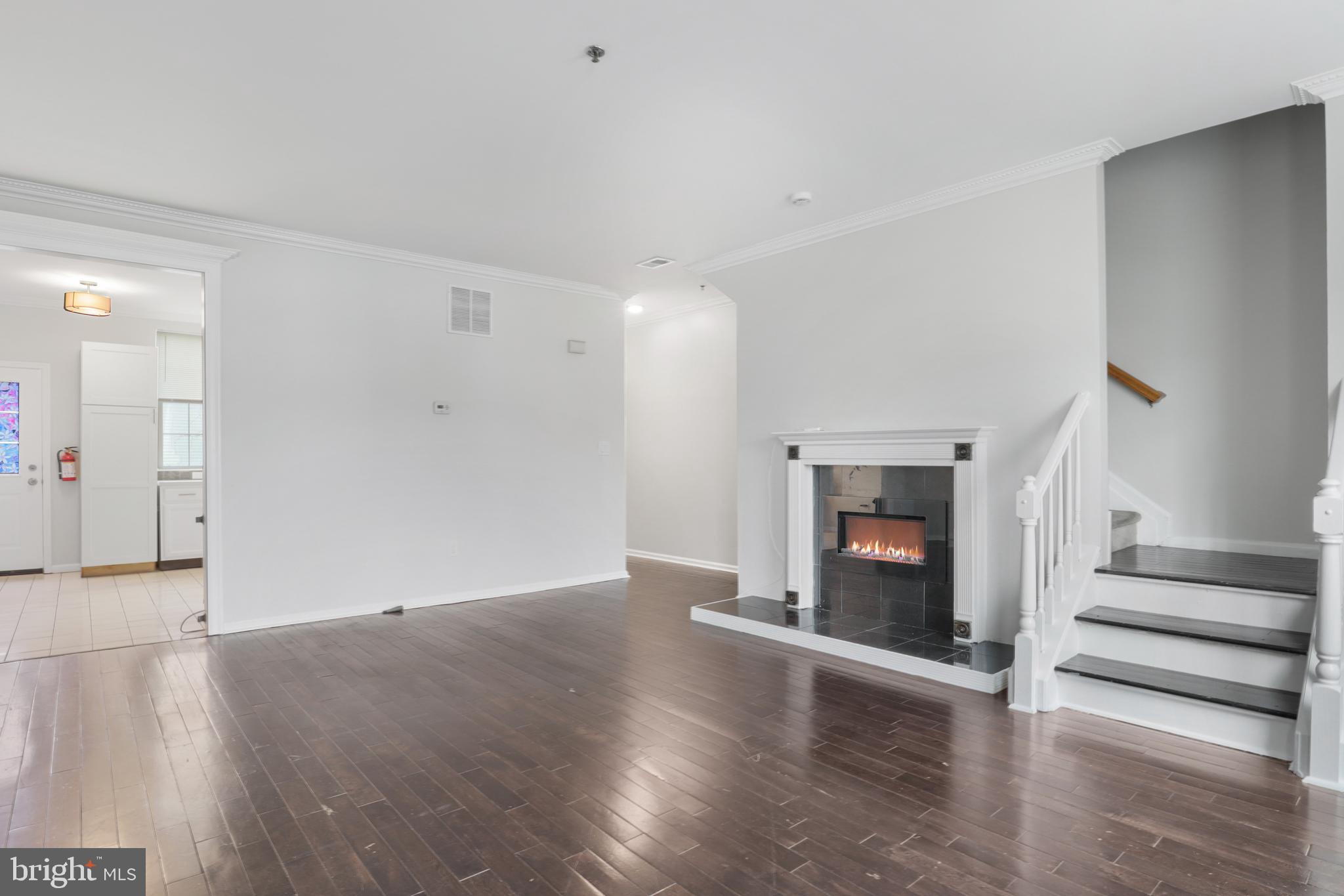130B Remsen Avenue New Brunswick, NJ 08901 - Photo 8 of 33 an empty room with wooden floor and fireplace
