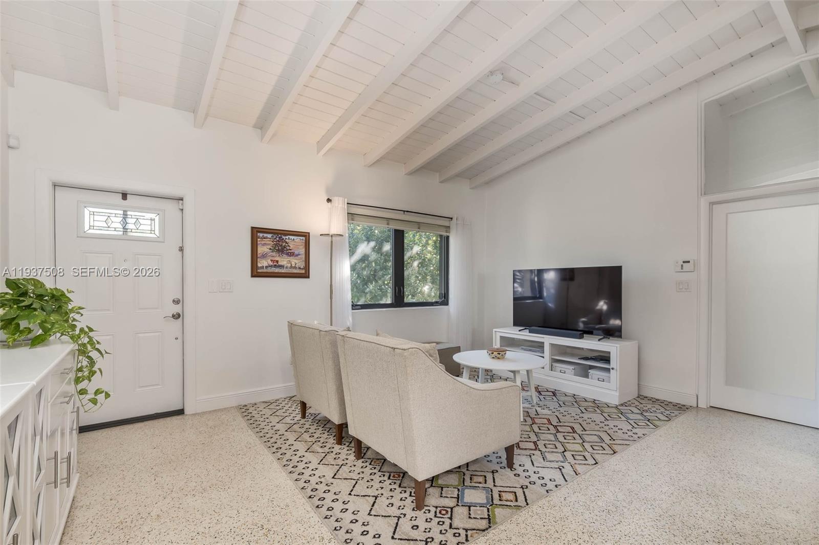 7720 Southwest 59th Court South Miami, FL 33143 - Photo 3 of 34 a living room with furniture and a flat screen tv