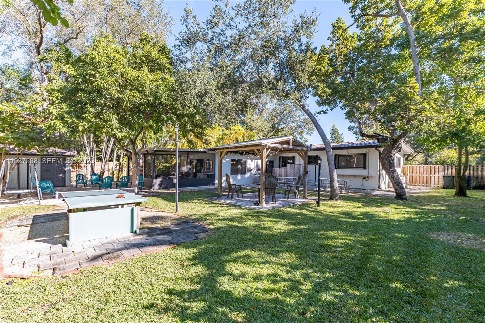 7720 Southwest 59th Court South Miami, FL 33143 - Photo 34 of 34 a swimming pool with outdoor seating and yard