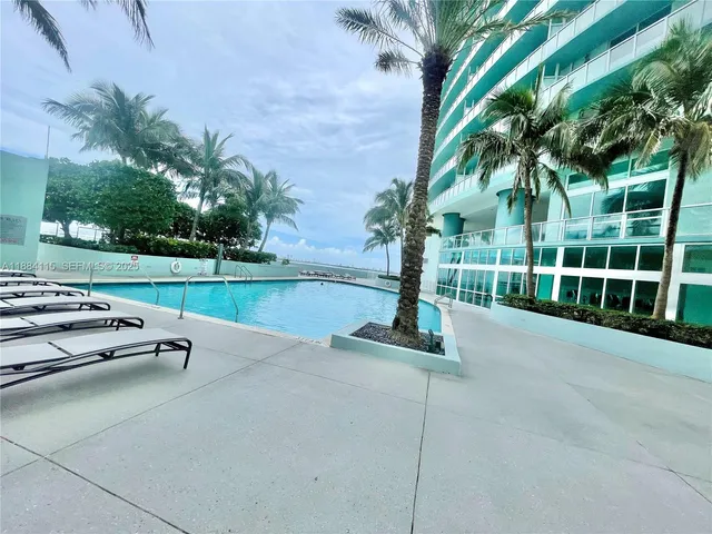 a view of a glass door and a yard from a balcony