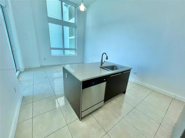 a utility room with a sink washer and dryer