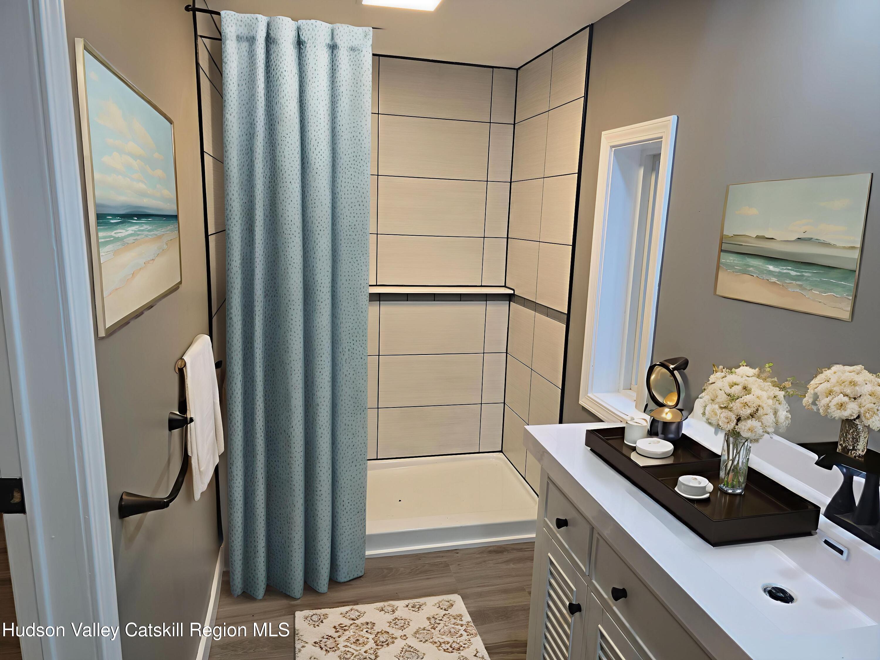 281 Bronck Mill Road Coxsackie, NY 12192 - Photo 3 of 9 a bathroom with a tub shower sink and mirror