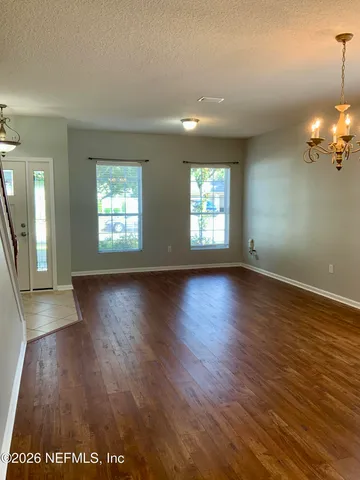 a kitchen with stainless steel appliances granite countertop a stove top oven a sink dishwasher and a refrigerator with wooden cabinets