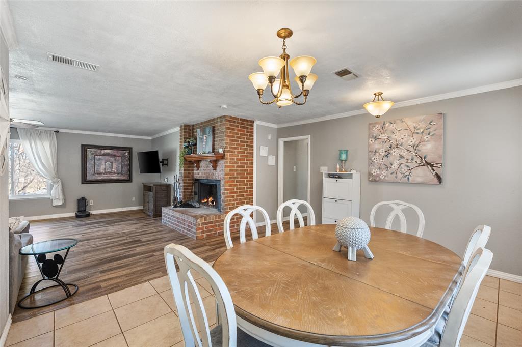 600 Bluff Springs Road Fort Worth, TX 76108 - Photo 12 of 40 a view of a dining room with furniture a chandelier and wooden floor