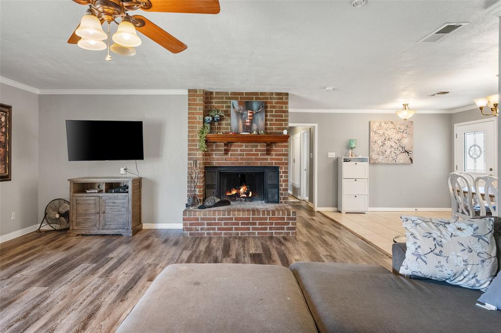 600 Bluff Springs Road Fort Worth, TX 76108 - Photo 13 of 40 a living room with furniture a flat screen tv and a fireplace