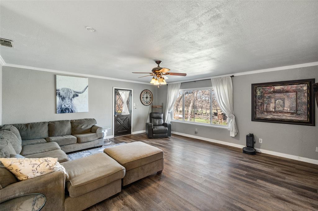 600 Bluff Springs Road Fort Worth, TX 76108 - Photo 15 of 40 a living room with furniture a large window and a chandelier