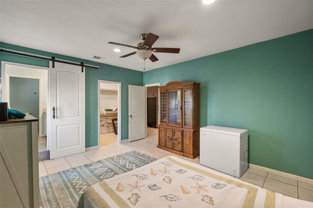 600 Bluff Springs Road Fort Worth, TX 76108 - Photo 22 of 40 a bedroom with a bed and a television in it