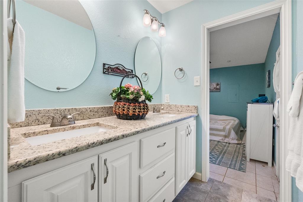 600 Bluff Springs Road Fort Worth, TX 76108 - Photo 23 of 40 a bathroom with a granite countertop sink and a mirror