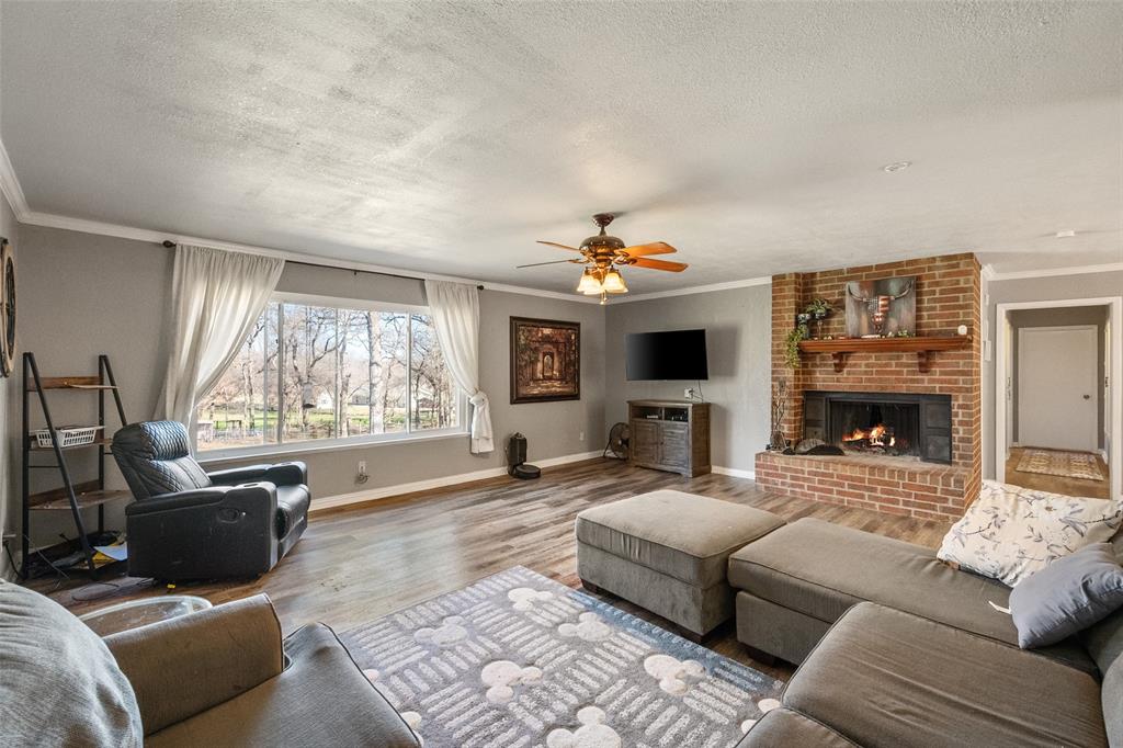 600 Bluff Springs Road Fort Worth, TX 76108 - Photo 4 of 40 a living room with furniture a large window and a fireplace
