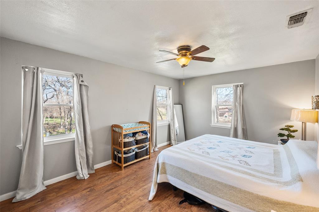 600 Bluff Springs Road Fort Worth, TX 76108 - Photo 6 of 40 a bedroom with a bed and a chandelier