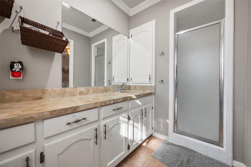 600 Bluff Springs Road Fort Worth, TX 76108 - Photo 7 of 40 a bathroom with a sink a mirror and a shower