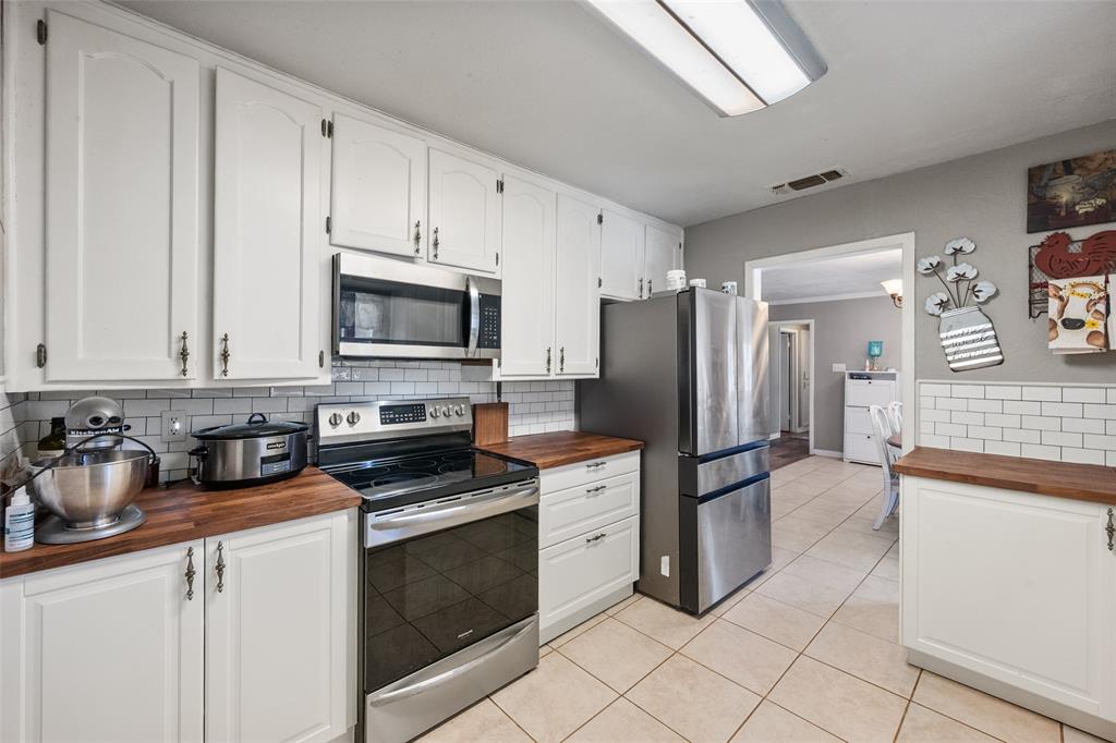 600 Bluff Springs Road Fort Worth, TX 76108 - Photo 9 of 40 a kitchen with granite countertop a stove sink and refrigerator