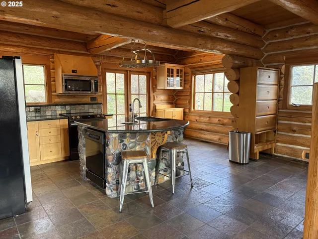 a kitchen with stainless steel appliances granite countertop a stove and a refrigerator