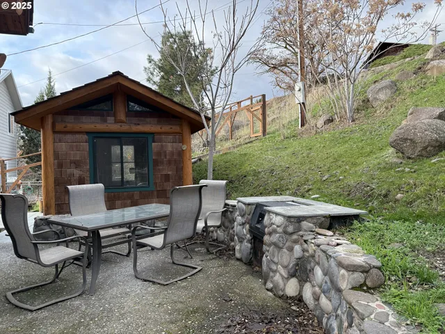 a view of a chairs and table in backyard of the house