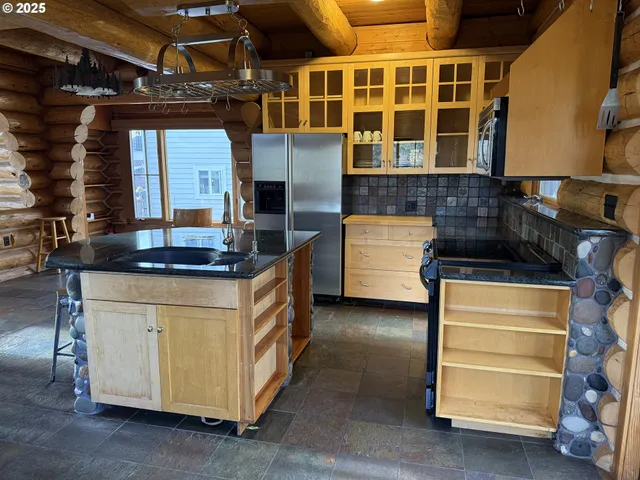 a kitchen with stove and cabinets