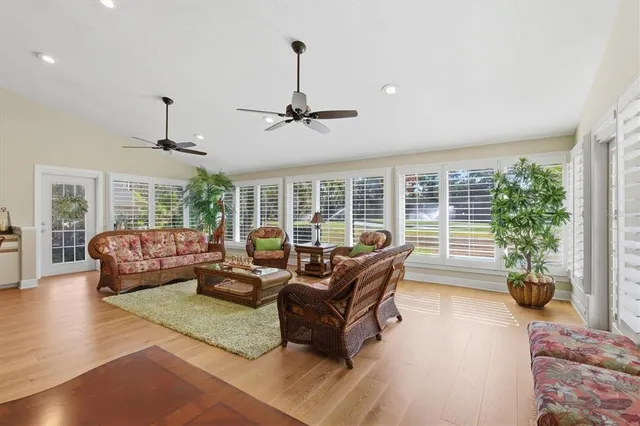 a living room with furniture and a ceiling fan