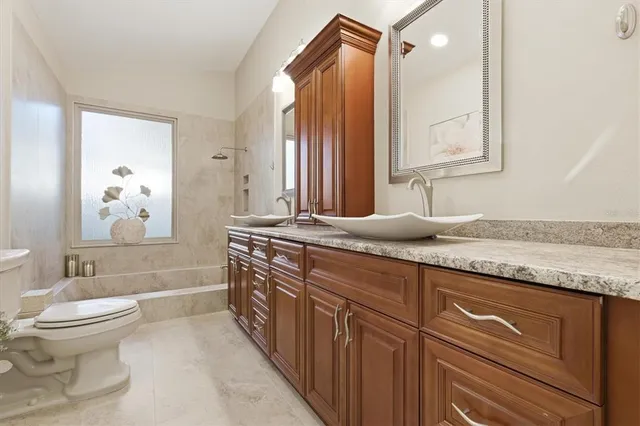 a bathroom with a toilet a sink and mirror