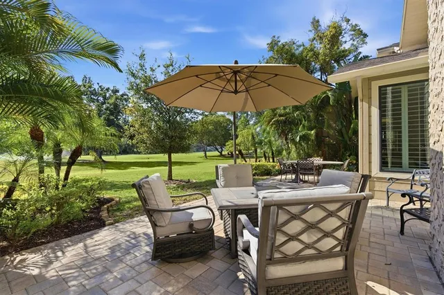 an aerial view of a house with a garden and lake view