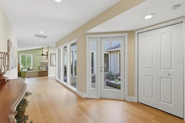 a living room with furniture a fireplace and a floor to ceiling window