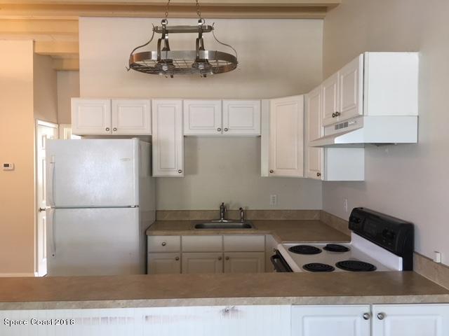 1708 Elm Street, Unit 8 Rockledge, FL 32955 - Photo 5 of 9 a kitchen with cabinets and appliances