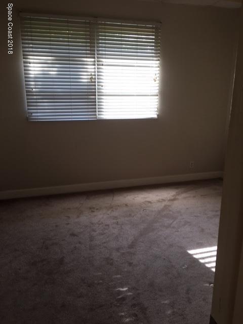 1708 Elm Street, Unit 8 Rockledge, FL 32955 - Photo 7 of 9 a view of an empty room with a window