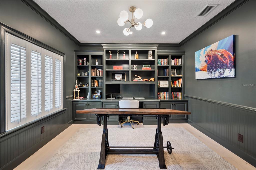 1909 New Jersey Road Lakeland, FL 33803 - Photo 17 of 93 a view of a workspace with furniture and a bookshelf