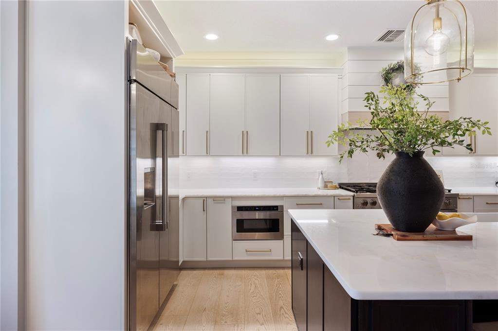 1909 New Jersey Road Lakeland, FL 33803 - Photo 24 of 93 a kitchen with kitchen island a stove a sink and a refrigerator