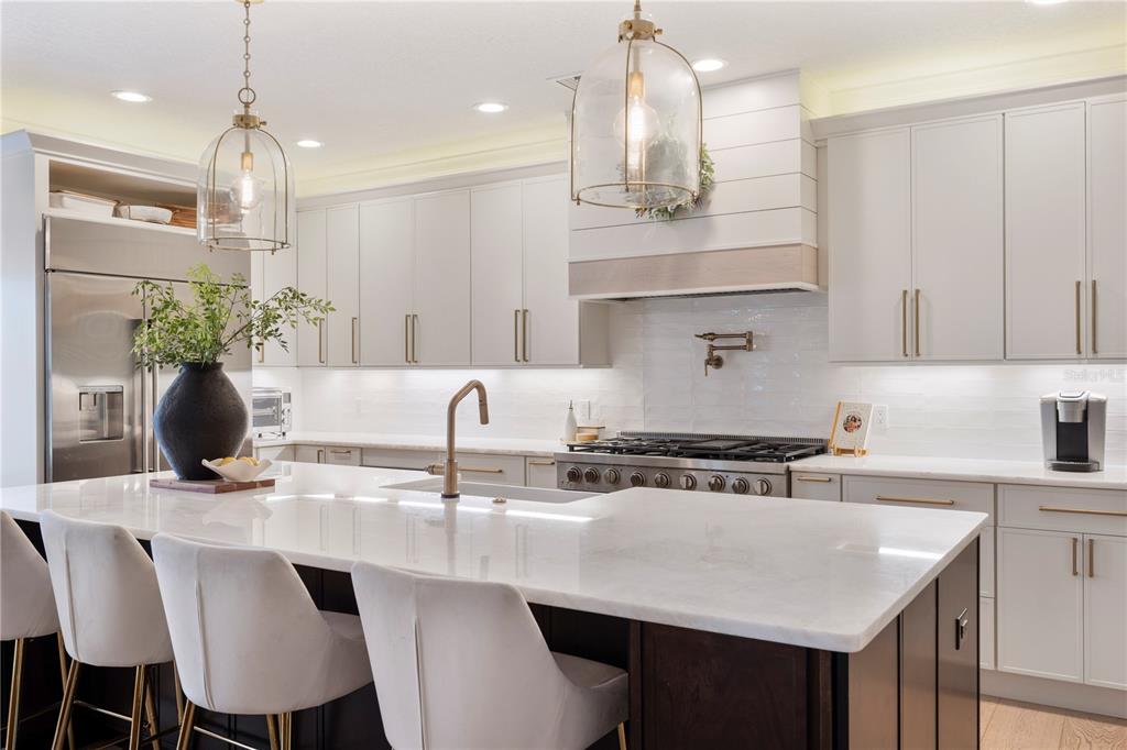 1909 New Jersey Road Lakeland, FL 33803 - Photo 25 of 93 a kitchen with stainless steel appliances a table chairs in it and kitchen view