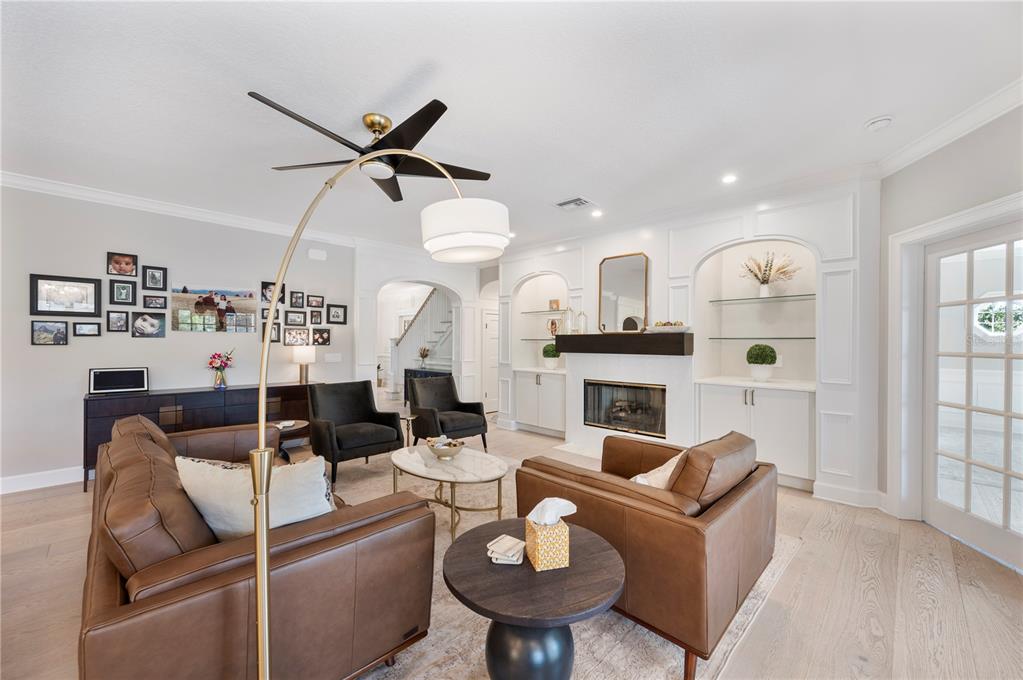 1909 New Jersey Road Lakeland, FL 33803 - Photo 30 of 93 a living room with furniture a fireplace and a chandelier