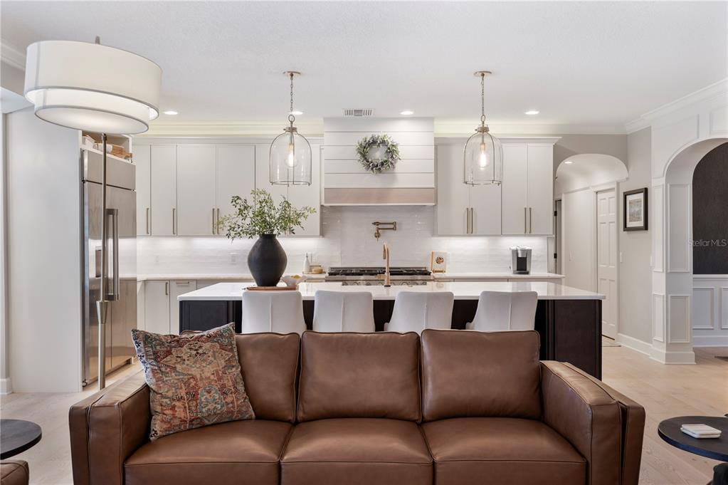 1909 New Jersey Road Lakeland, FL 33803 - Photo 32 of 93 a kitchen with stainless steel appliances kitchen island granite countertop a refrigerator a sink dishwasher a dining table and chairs with wooden floor