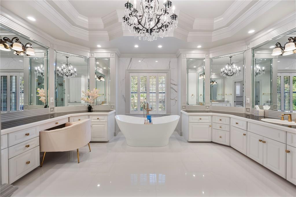 1909 New Jersey Road Lakeland, FL 33803 - Photo 47 of 93 a large white bathroom with a large tub sink vanity granite and a mirror